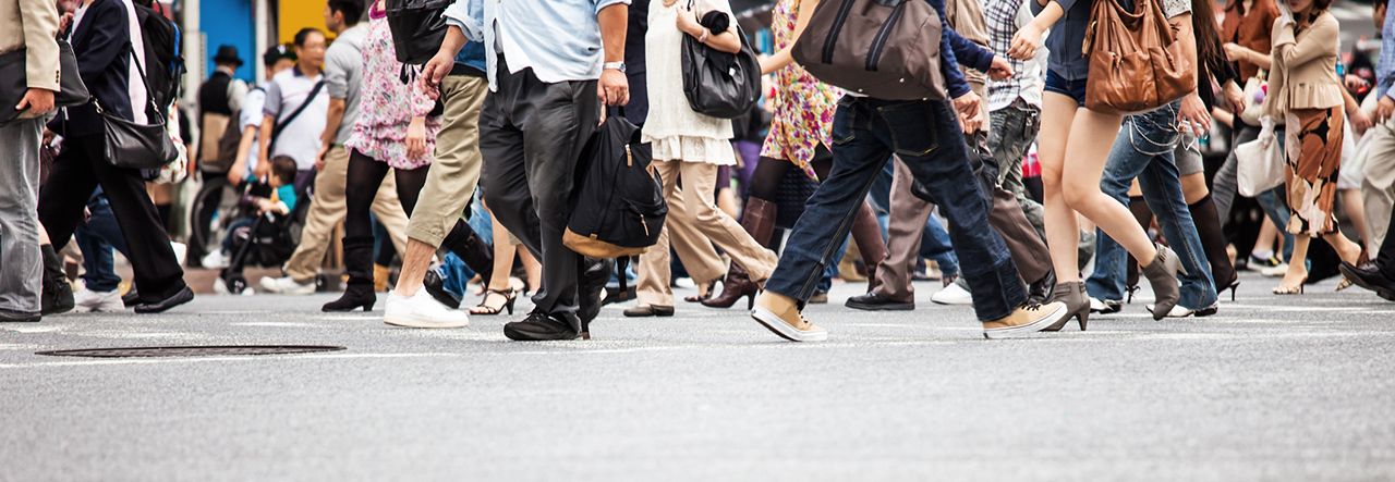 Crowd of people crossing the road