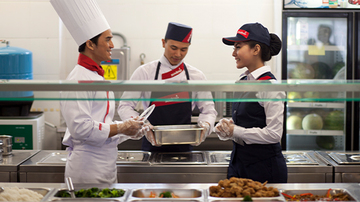 3 Sodexo chefs standing in front of a counter