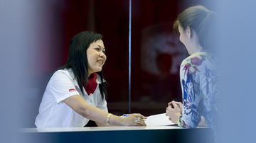 Sodexo receptionist serving a customer